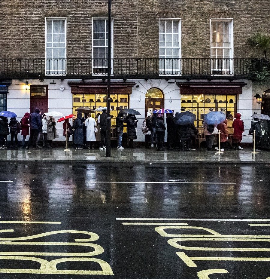 People queueing in rain