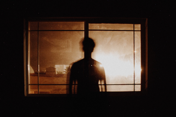 man silhouette at window