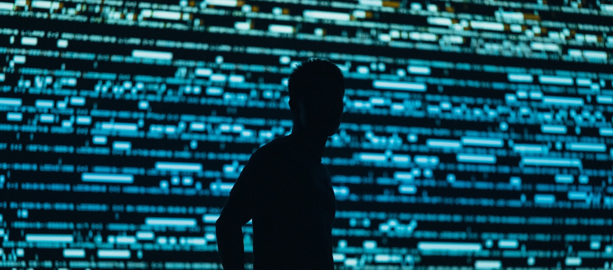Man in front of screen of code